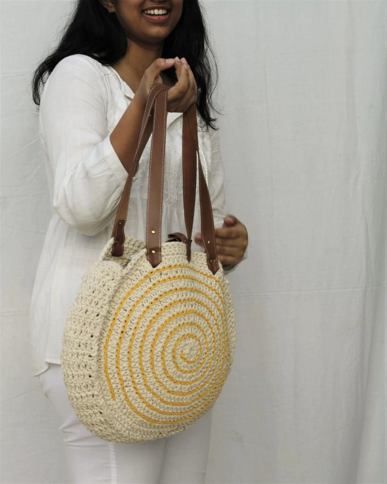 Elevate your accessories with this direct-from-craftsman everyday tote, hand-crocheted from high-quality cotton yarn.