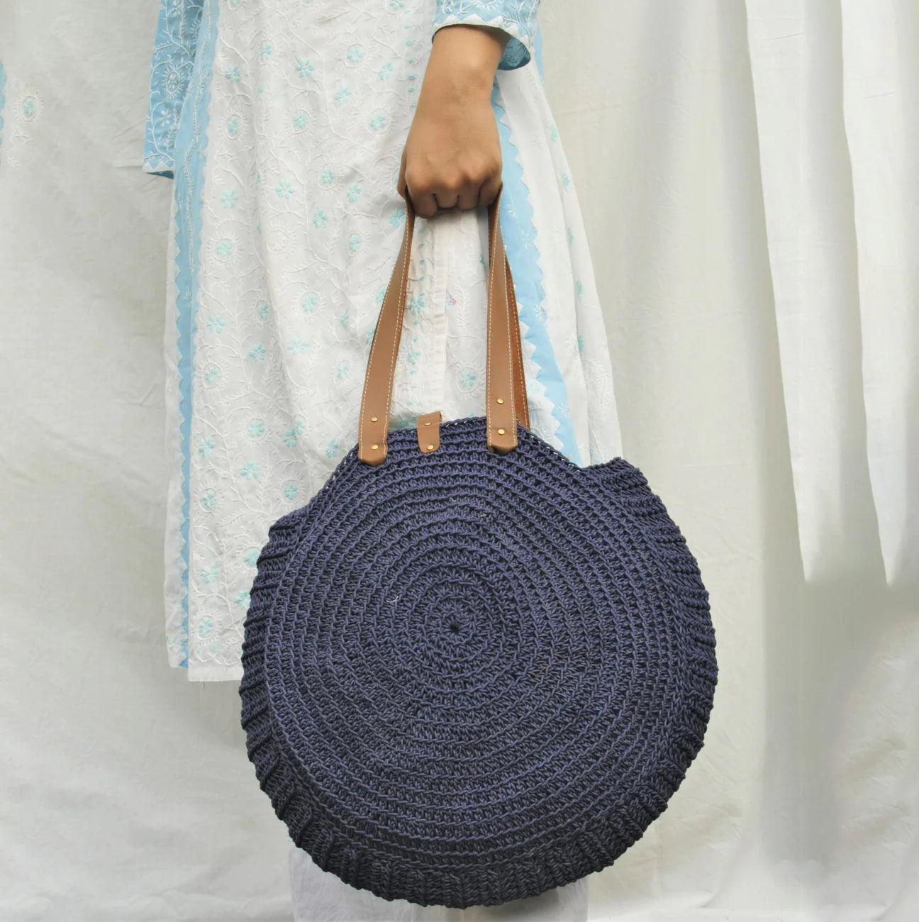 Effortlessly stylish and crafted with precision, this everyday tote bag is meticulously hand-crocheted from high-quality cotton yarn, promising both durability and a hint of handmade elegance.